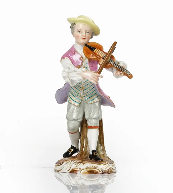 A Meissen outside decorated figure of a young man playing the violin, 19th century, modelled standing against a tree stump, blue cancelled crossed...