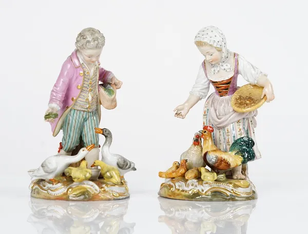 A pair of Meissen figure groups  late 19th century, modelled as a boy and girl feeding chickens and geese and their young, blue crossed swords marks,...