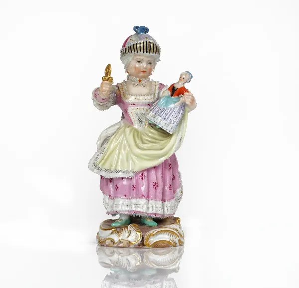 A Meissen figure of a girl, late 19th century,  standing holding a doll and rattle, blue crossed swords mark, incised C.79, impressed 62, 14.25cm....