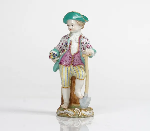 A Meissen figure of a boy gardener, 19th century, modelled standing with one foot resting on a spade and holding a posy of flowers in his right hand,...