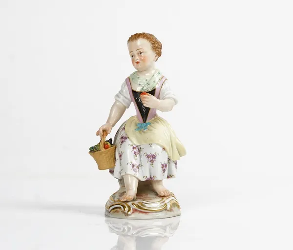 A Meissen figure of a girl, late 19th/early 20th century, modelled seated holding a basket of fruit in her right hand and an apple in her left hand,...