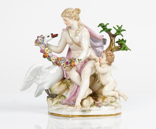 A Meissen outside decorated group of Leda and the Swan, late 19th century, the maiden seated on a tree stump with cupid at her side, draping a floral...