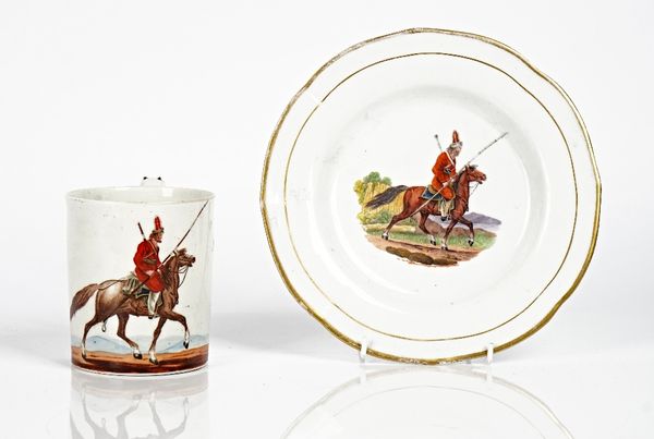 An English porcelain cylindrical mug, circa 1815, printed and coloured with a Don Cossack on horseback, blue painted title, `A Don Cossack', (a.f),...