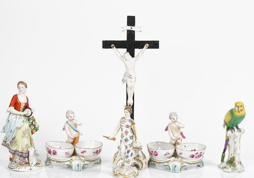 A group of Continental porcelain, late 19th/20th century, comprising; a pair of German double salts with central putto, 12.75cm. high; a shepherdess...