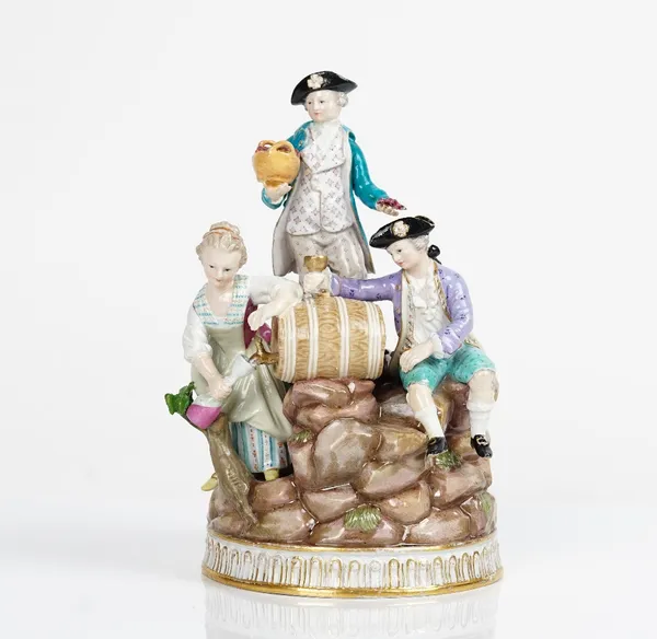 A Meissen group of vintagers, late 19th century, modelled as young woman pouring wine from a flask, a young man seated beside with a goblet and...