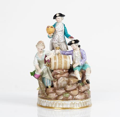 A Meissen group of vintagers, late 19th century, modelled as young woman pouring wine from a flask, a young man seated beside with a goblet and...
