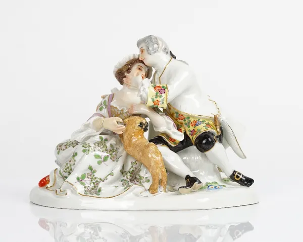 A Meissen group of lovers, 20th century, after J.J Kaendler, modelled as a gallant and companion seated in an embrace with a pug dog standing up...