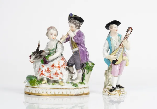 A Meissen group of vintners, late 19th century, modelled with girl seated on the back of a goat, a boy standing beside before a hod of grapes and...