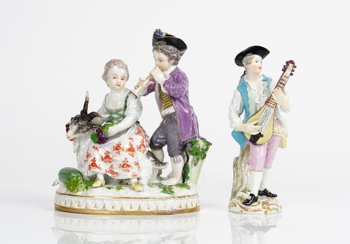 A Meissen group of vintners, late 19th century, modelled with girl seated on the back of a goat, a boy standing beside before a hod of grapes and...