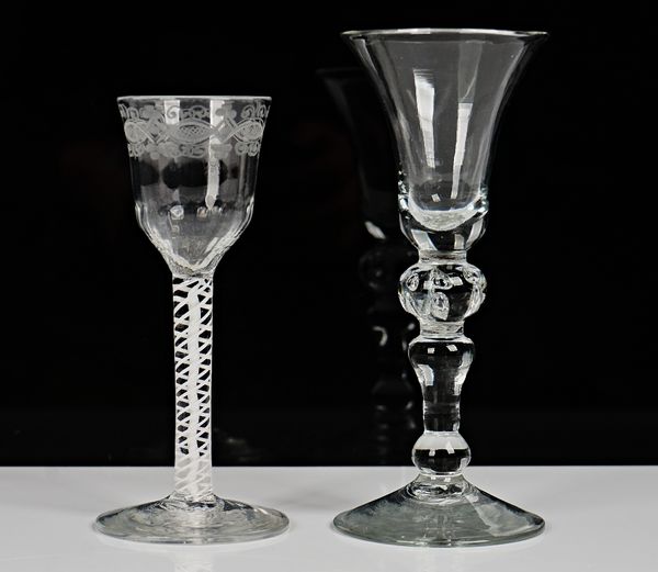 An opaque twist wine glass, circa 1765, the moulded ogee bowl engraved with a foliate border, raised on a double series opaque twist stem and plain...