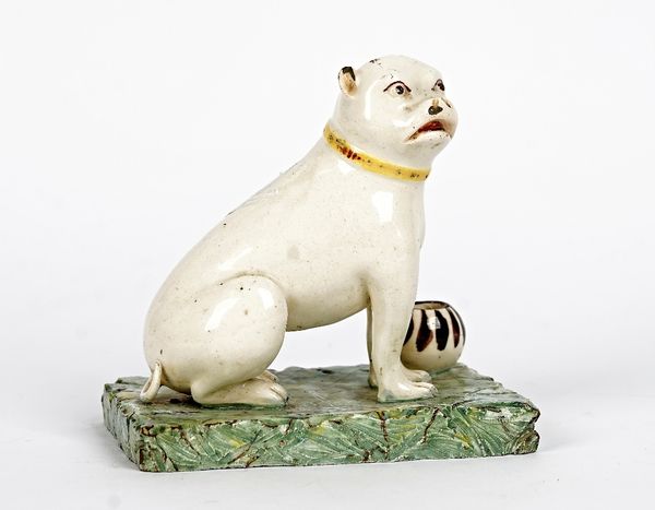 A Continental earthenware figure of a pug dog