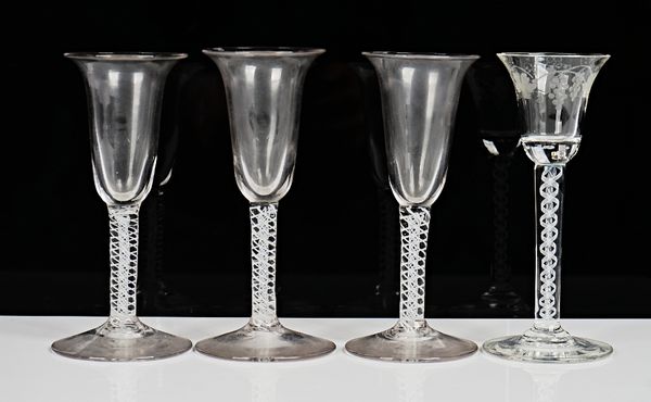 An opaque twist wine glass, 20th century, the bell bowl engraved with fruiting vine, raised on a double series opaque twist stem, 15.5cm. high; also...