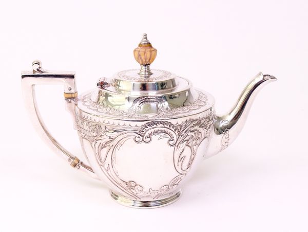 A Victorian silver teapot, embossed with foliate scrolls and flowers and with an urn shaped finial to the lid, Sheffield 1897, a matching sugar bowl,...