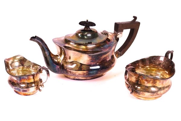 A silver three piece tea set, comprising; a teapot with ebonised fittings, a twin handled sugar bowl and a milk jug, each piece of waisted oval form,...