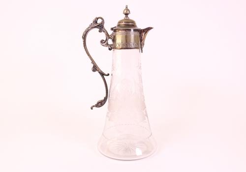 A Victorian silver plated metal mounted glass claret jug and a bottle coaster (2)