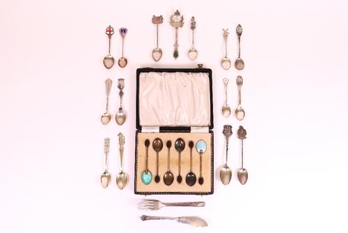 A group of silver table flatware, comprising; a set of six coffee spoons, with differing coloured enamelled decoration to the backs of the bowls and...