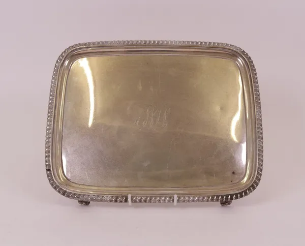 A George III rectangular salver, decorated with a gadrooned rim, raised on four tapered feet and monogram engraved to the centre, 28cm x 22.5cm,...