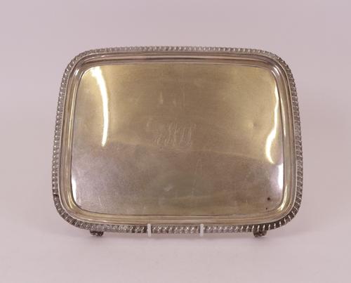 A George III rectangular salver, decorated with a gadrooned rim, raised on four tapered feet and monogram engraved to the centre, 28cm x 22.5cm,...