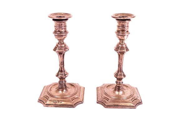 A pair of late Victorian small candlesticks, modelled as mid-18th century taper sticks, Birmingham 1897, by Elkington & Co Ltd, (loaded), height 12cm.