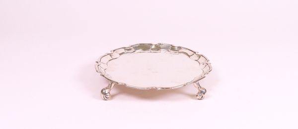 A George III shaped circular silver waiter, Richard Pargeter, London 1762, with moulded edge, on four scroll feet, 8.4ozs, 16.5cm diameter.