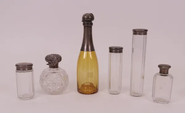 A Victorian silver mounted amber coloured glassware small decanter, modelled as a champagne bottle, monogram engraved, London 1893, four silver...