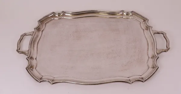 A silver shaped rectangular twin handled tray, having a raised rim, length including handles 61cm, Sheffield 1919, weight 2465 gms.