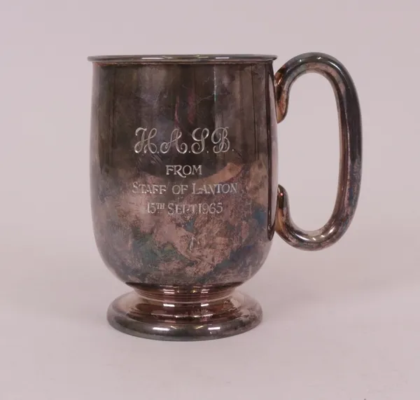 A silver mug, with a 'C' shaped handle, raised on a circular foot, the body presentation inscribed, Sheffield 1958, height 12.5cm, weight 339 gms.  7093