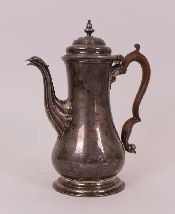 A late George II silver coffee pot, of baluster form, with a replacement wooden handle