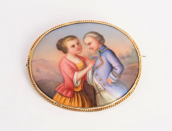 A European enamelled oval ceramic gold mounted brooch.