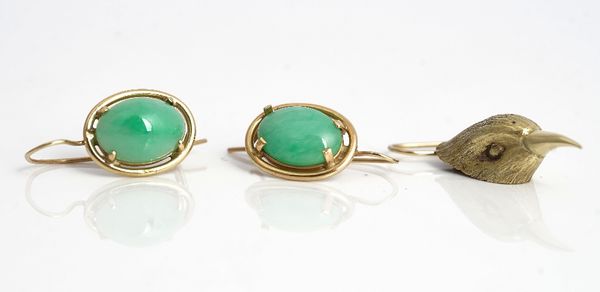 A pair of jade earrings, each claw set with an oval jade and a single earring, designed as a bird's head, having a wire fitting, (2).