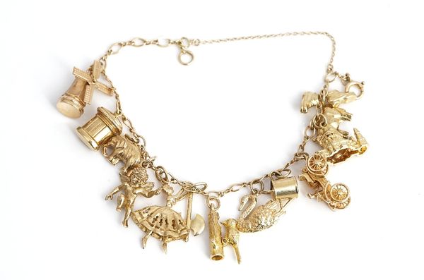 A 9ct gold charm bracelet, fitted with twelve mostly 9ct gold charms, including a ballerina, a woodpecker, a vintage car and a pair of boots, gross...