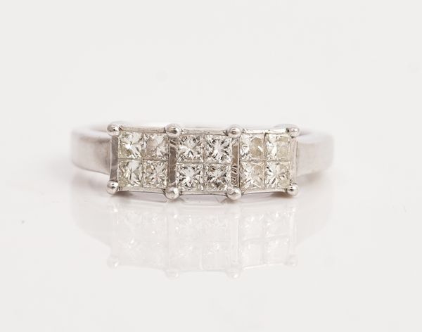 An 18ct white gold and diamond ring, designed as a row of three four stone square clusters, each mounted with four princess cut diamonds, ring size H...