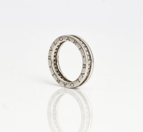 A Bvlgari white gold and diamond full eternity ring, mounted with circular cut diamonds, the sides of the band detailed Bvlgari twice, ring size L,...