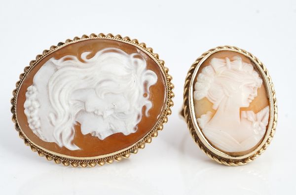 A 9ct gold and oval shell cameo ring, carved as the portrait of a lady within a ribbon twist surround, between split shoulders, ring size U and a...