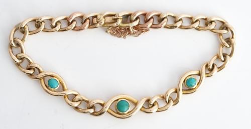 A gold and turquoise set curb link bracelet, on a snap clasp, detailed 15 CT, fitted with a safety chain, circa 1910, gross weight 12.2.gms.