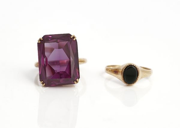 A 9ct gold and rectangular cut mauve gem set solitaire ring, ring size O and a 9ct gold and oval black onyx solitaire ring, ring size M and a half,...
