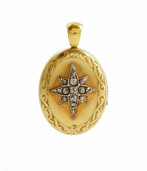 A Victorian gold and diamond set hinged locket pendant of oval design, mounted with a star set with graduated mine cut diamonds with photograph...
