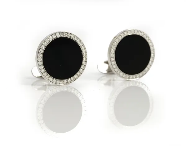 A pair of white gold, diamond and black onyx dress cufflinks