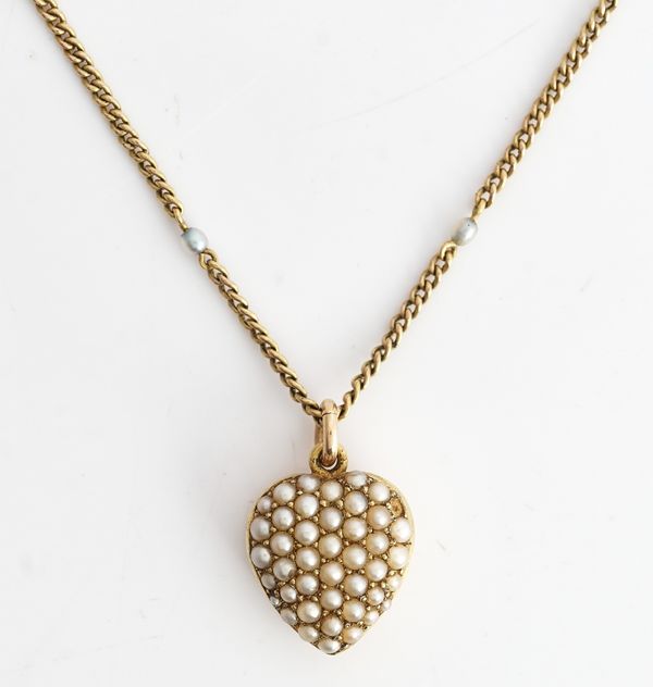 A gold and seed pearl set heart shaped pendant locket, the front pave set with seed pearls, the back glazed with a locket compartment and detailed 15...