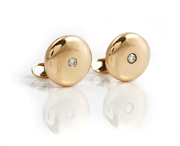 A pair of gold and diamond single stone dress cufflinks, each domed circular front mounted with a circular cut diamond at the centre, detailed 0 10...