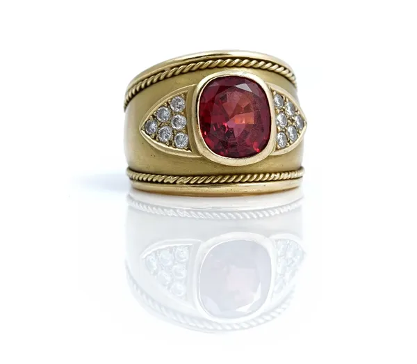 An 18ct gold, red spinel and diamond ring, collet set with the oval cut red spinel to the centre, between circular cut, diamond set six stone...