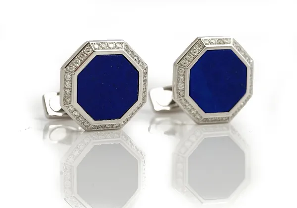 A pair of white gold, lapis lazuli and diamond set dress cufflinks, each octagonal front mounted with a lapis lazuli to the centre in a surround of...