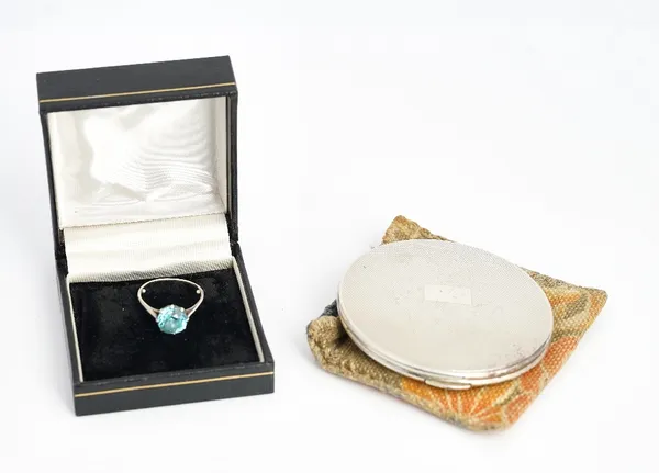 A blue zircon single stone ring, claw set with a circular cut blue zircon, ring size Q, (note sizing beads), a lady's Kigu silver powder compact,...