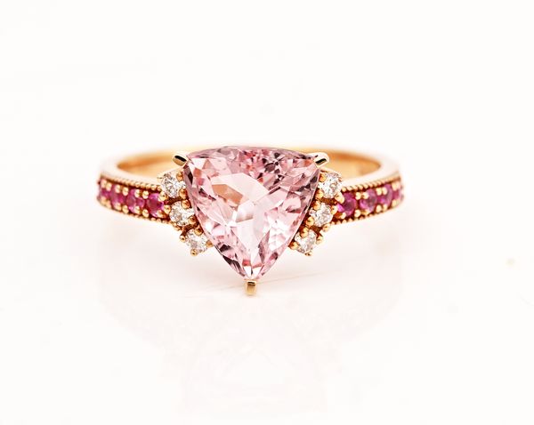 A rose colour gold, morganite, pink sapphire and diamond ring, claw set with the curved triangular morganite between diamond three stone shoulders...
