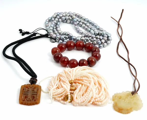 A multiple row necklace of five rows of coral beads and seven rows of small cultured pearls, on a coral bead twist clasp, a long single row necklace...