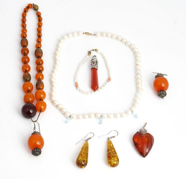A pair of reconstituted amber drop shaped pendant earrings, a reconstituted amber heart shaped pendant, a single row necklace of freshwater cultured...