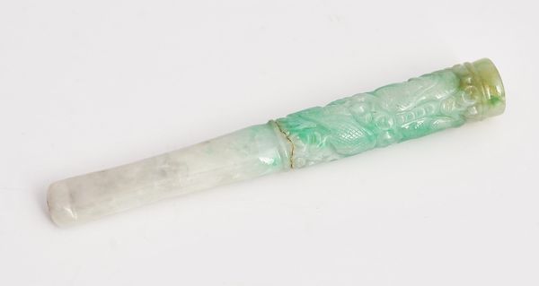 A carved jade cigarette holder.