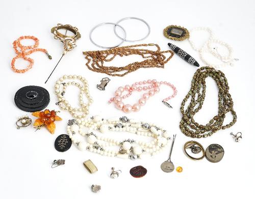 A collection of jewellery, including; a Victorian black enamelled mourning brooch, glazed with a central locket compartment,