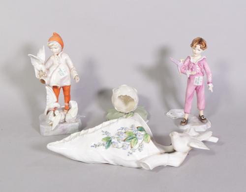 A Royal Worcester wall pocket, two Royal Worcester figures and another smaller wall pocket (4)