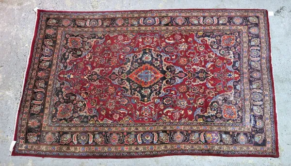 A Mashhad rug, madder field, black medallion, 306cm x 190cm